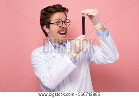 Scientist Hlding A Glass Tube With Blue Fluid Being Happy He Made A Great Discover.