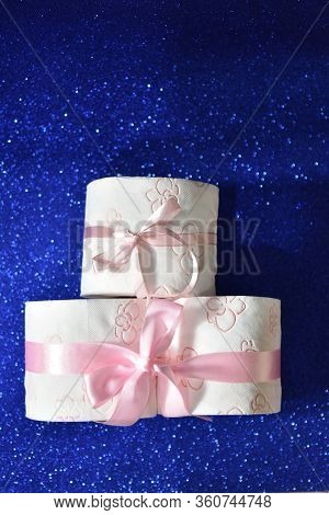 Rolls Of Toilet Paper On Glitter Blue Background