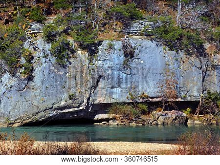 Rugged Granite Cliffs Overhang Aqua Blue Water On The Buffalo National River Outside Of Harrison, Ar