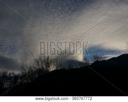 Clouds In A Sunny, Windy Sky. Play Of Light Between Mountain Shadows, Cloudy Skies In Blue And White