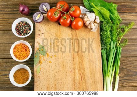 Wooden Board With Clear Space. Around Tomato And Dill, Olive Oil, Peper, Avocado, Green Onion, Spina