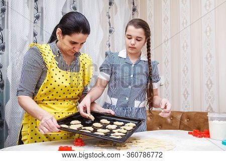 Mom And Daughter Bake Homemade Cookies In The Citchen. Coronavirus Quarantine
