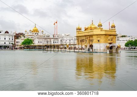 Golden Temple (known As Harmandir Sahib) In Amritsar, Punjab, India In Cloudy Weather With Grey Sky 