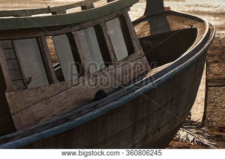 Hull And Deckhouse Of A Wooden Boat Lying On The Shore Due To Low Tide, Close-up