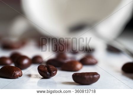 Coffee Beans And A White Cup On The Kitchen Table