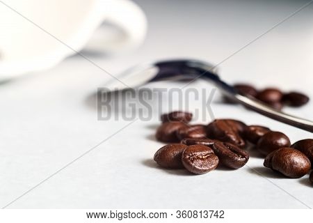 Coffee Beans And A White Cup On The Kitchen Table