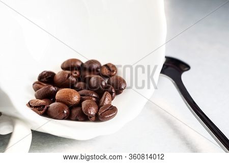 Coffee beans and a white Cup on the kitchen table
