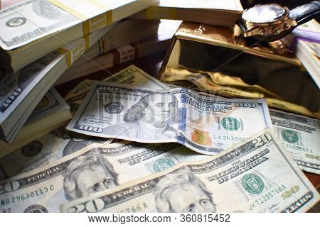 Business & Finance Affluence Concept With Stacks Of Cash With Gold Bar & Luxury Watch