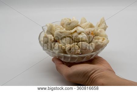 Hand Serving Jumbo Lump Of Fresh Crab Meat In Decorative Glass Bowl Isolated On White Background. Re