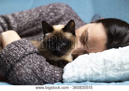 Woman Feeling Sick And Have Cramps Lying On Sofa And Have Some Medicamentation On Table