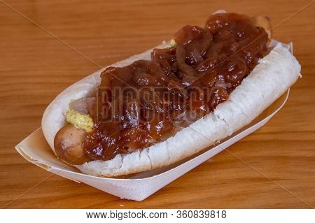 Chili Hot Dog Topped With Cheese And Sweet Onion