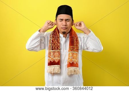 In Ramadan Kareem Young Asian Muslim Man Try To Cover His Ears  To Do Not Listen Useful Things When 