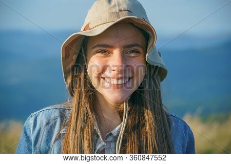 Portrait Of Beautiful Woman Smiling And Looking Away At Park During Nuture. Outdoor Portrait Of A Sm