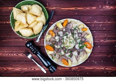 Beshbarmak Dish With Baursak - Traditional Kazakh Asia Food And National Bread. Noodles With Lamb An