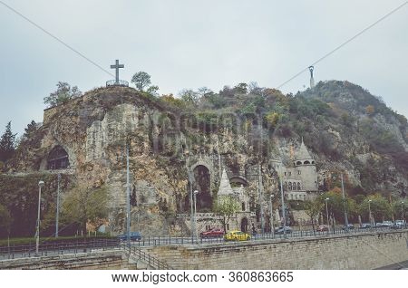 Budapest, Hungary - Nov 6, 2019: Gellert Hill Cave Church, Sziklatemplom. Liberty Statue On The Top 