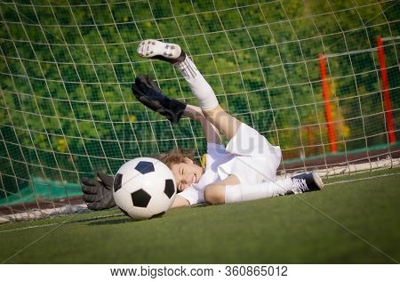 Summer Soccer Tournament For Young Kids. Football Club. Emotions And Joy Of The Game. Young Goalie. 