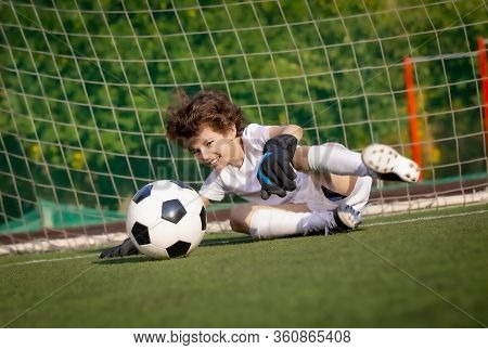 Summer Soccer Tournament For Young Kids. Football Club. Emotions And Joy Of The Game. Young Goalie. 