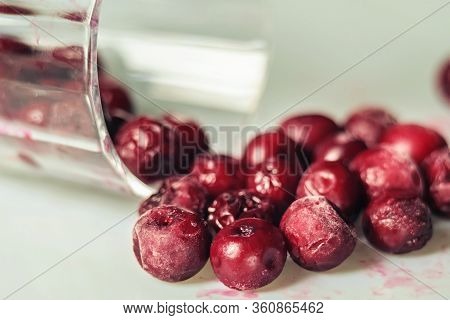 Closeup Of Frozen Cherry In The Glass On White Surface. Selective Focus