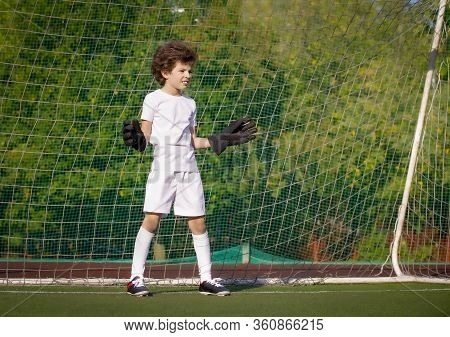 Summer Soccer Tournament For Young Kids. Football Club. Emotions And Joy Of The Game. Young Goalie. 