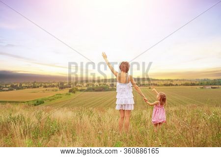 Back View Of Beautiful Couple Mother And Cute Daughter Standing Whith Raised Up Hands Enjoying Sunse