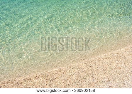 Beautiful empty beach at Adriatic sea in Croatia. Detailed shot. Summer concept. Sandy beach with turquoise water background