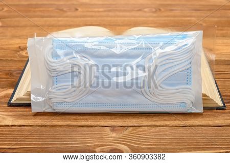 Pack Of Medical Masks And A Book
