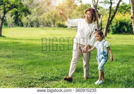 Portrait Of Enjoy Happy Love Asian Family Grandmother And Little Cute Girl Child Having Fun Relax Pl