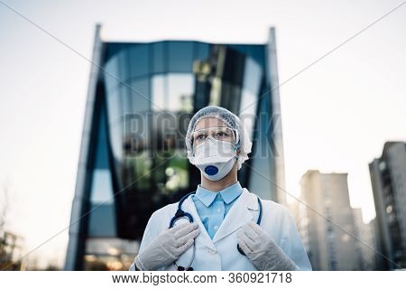 Coronavirus Doctor Standing In Front Of Modern Clinic Building,working In The Isolation Ward.medical