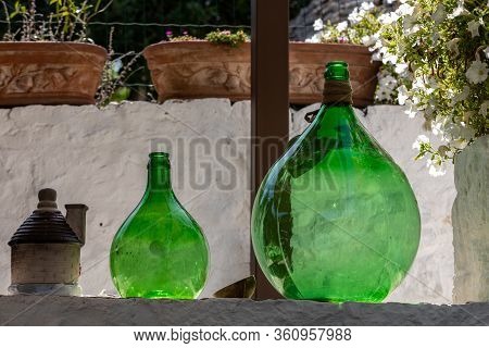Alberobello, Italy - Septembet 16, 2019: Demijohn Wine Bottles At Cafe In Trulli Village In Alberobe