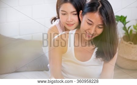 Asian Lesbian Couple Hug Each Other On Bed In Morning At Cozy Home