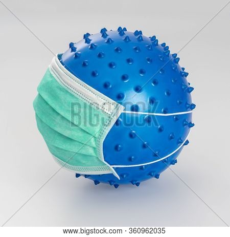 Picture Of A Symbolic Blue Virus Wearing A Face Mask In Light Back