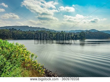 Lake Serene Blue Water With Misty Mountains And Clouds Reflections