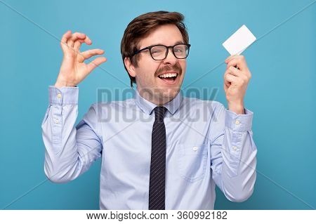 Man Show Small Size By Fingers Hodfing A Credit Card, Demonstrate Tiny Measure