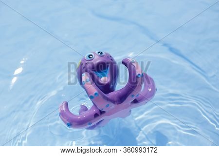 Purple Octopus Sweeming In The Blue Water.