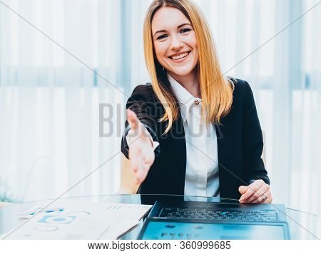 Successful Job Interview. Friendly Female Recruiter Holding Out Hand In Welcoming Gesture.