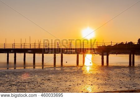 High Quality Photo Of A Pier At Sundown. Wooded Bridge Seaside With Sunset, Strunjan. Slovenia