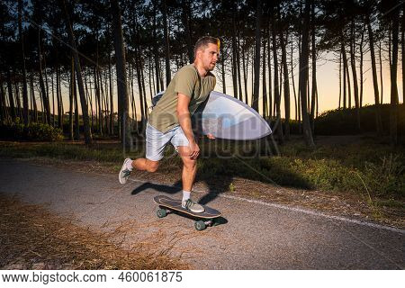 Surf Skater Rolling By The Pine Forest At Sunset