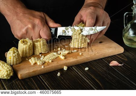 Professional Chef Cuts Boiled Corn Kernels With A Knife. Maize Is An Excellent Dietary Breakfast Or 