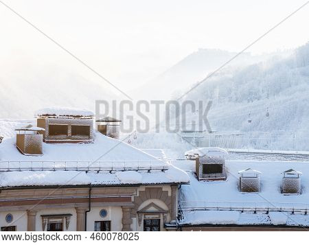 The Roof Of The Ski Hotel Against The Backdrop Of Snowy Mountains. Ski Resort Hotel On Foggy Day. Sk