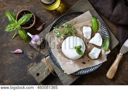 Homemade Italian Ricotta Cheese Or Cottage Cheese With Basil On A Rustic Table. Vegetarian Healthy D