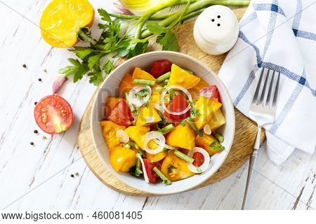 The Concept Of Vegan Or Diet Food. Tomato Salad Made From A Mix Of Red And Yellow Tomatoes And Green