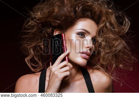 Beautiful Woman Handling Phon. Bright Makeup And Beautiful Hairstyle