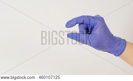 Empty Hand Holding Or Catch Nothing Guesture On White Background.hand Wear Violet Or Purple Latex Gl