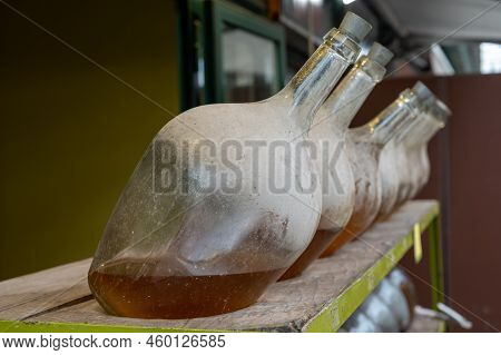 Big Bottles With White Wine Austrian Vinegar Made From Local Grapes On Market In Vienna, Austria