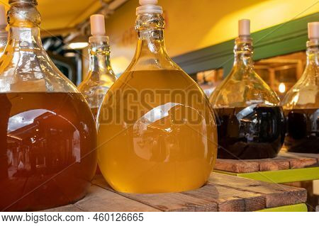 Big Bottles With White And Red Wine Austrian Vinegar Made From Local Grapes On Market In Vienna, Aus