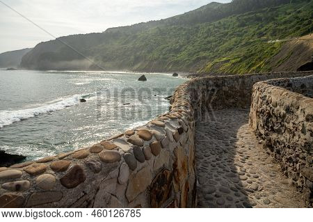 Stone Footpath To Famous Landmark And Film Location In North Of Spain, Ocean Islet With Chapel San J