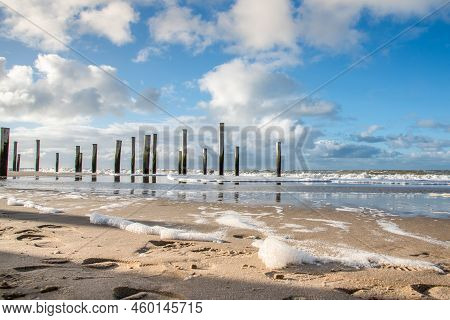 Petten Aan Zee, The Netherlands - January 9, 2021. The Wooden Poles - Palendorp - At The Beach Near 