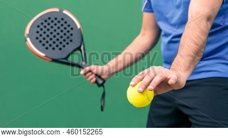 Professional Monitor Of Padel Holding A Yellow Ball And Black Racket. Sport Game