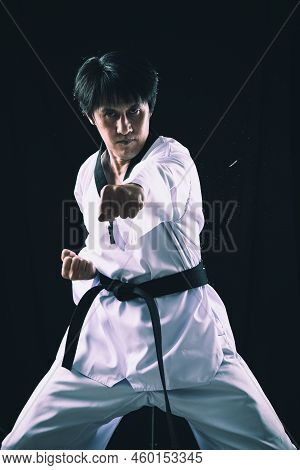 Black Red Belt Taekwondo Karate Male Athlete Man Show Traditional Fighting Poses Punch On Black Back