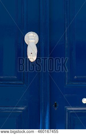 Blue Door With Unny White Handle In The Form Of Hand. Streets Of Village Of Pyrgos, Tinos Island, Cy